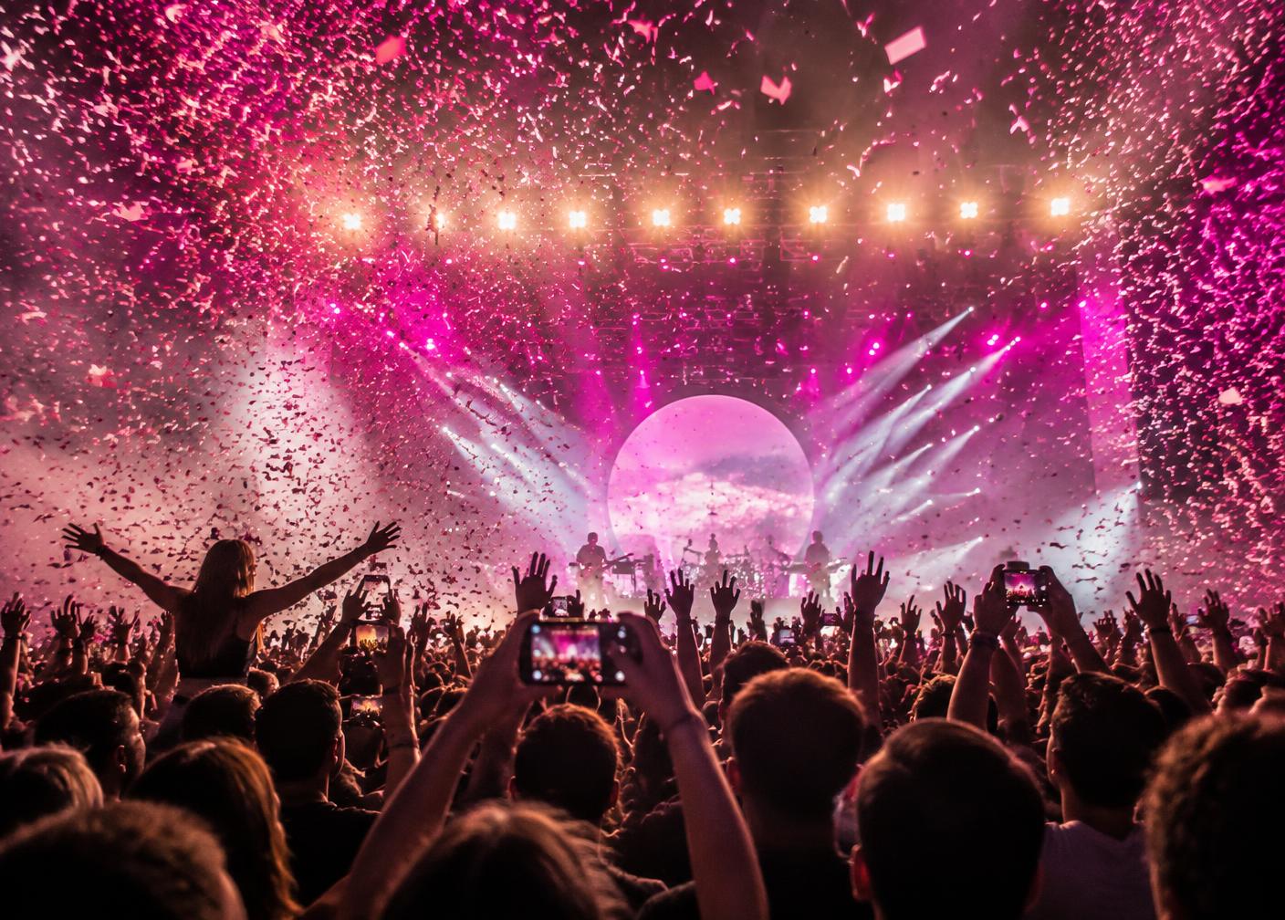 Concert crowd under falling confetti